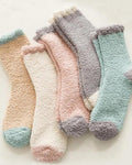Five pairs of fluffy bed socks in camel, cream, blush, grey and sage