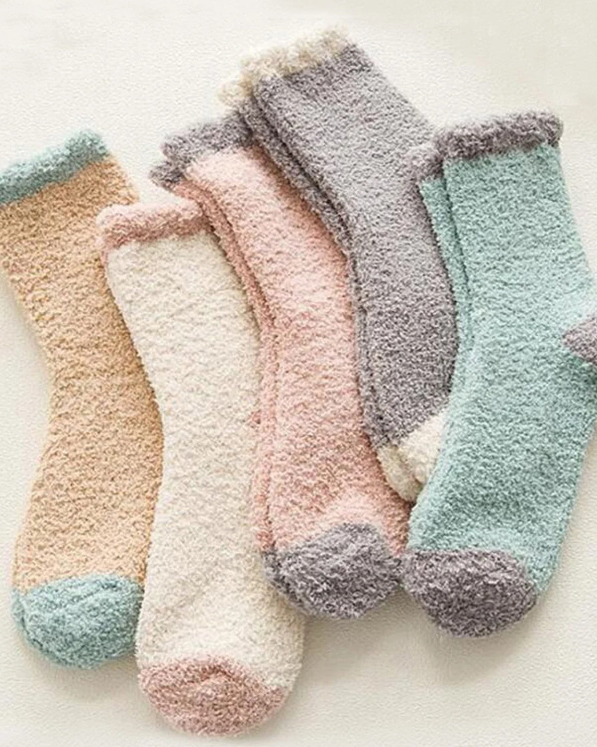Five pairs of fluffy bed socks in camel, cream, blush, grey and sage