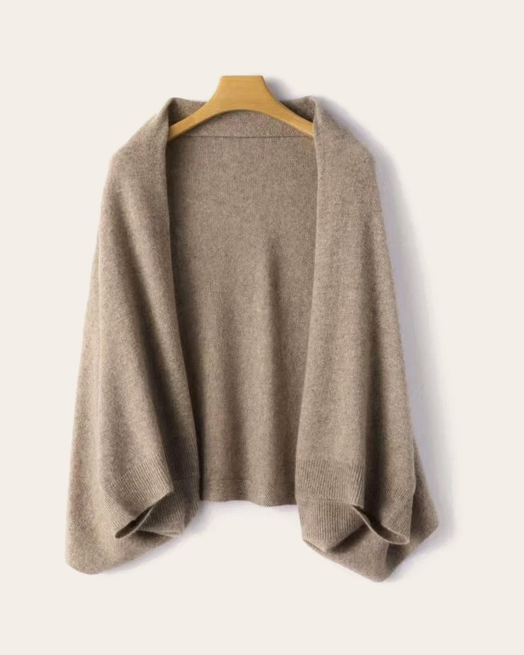 The Mabel Knit Wrap in Camel on a hanger