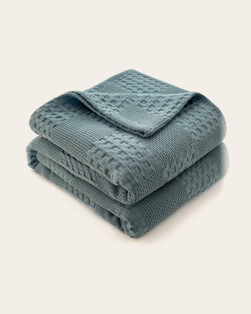 The Wren Cotton Waffle Throw in Dusty Blue, folded