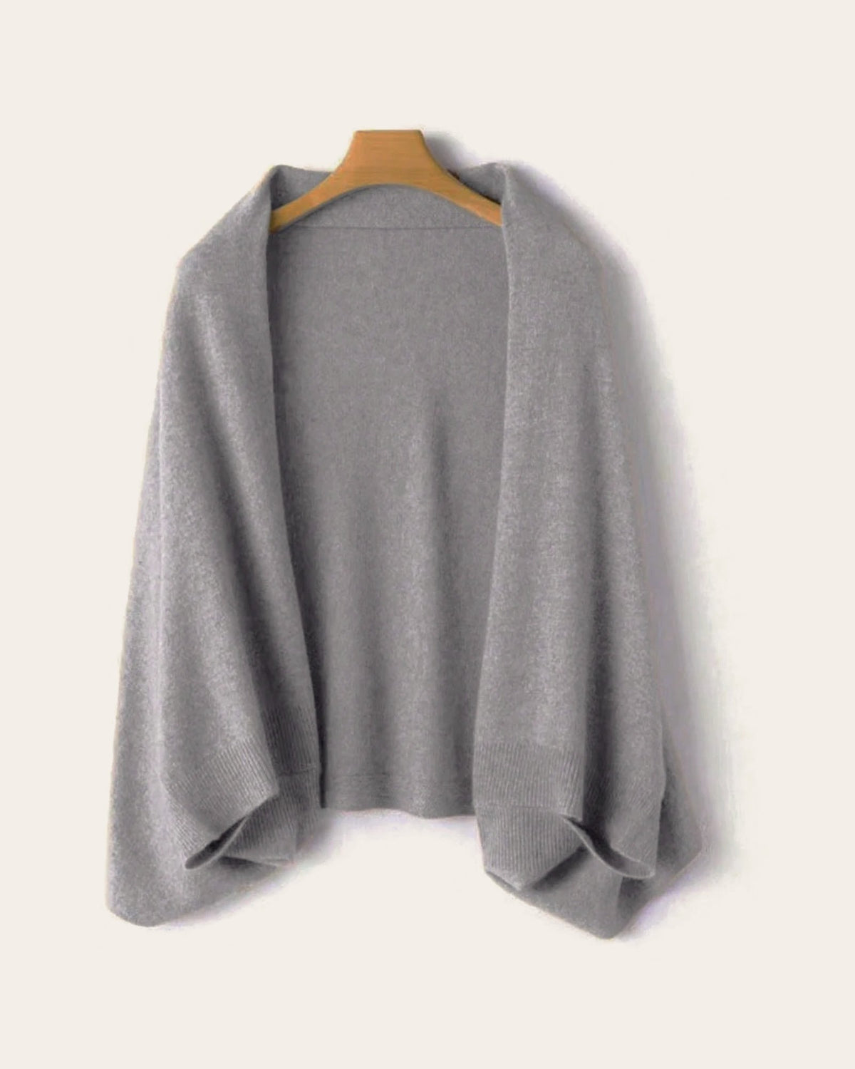 The Mabel Knit Wrap in Grey on a hanger