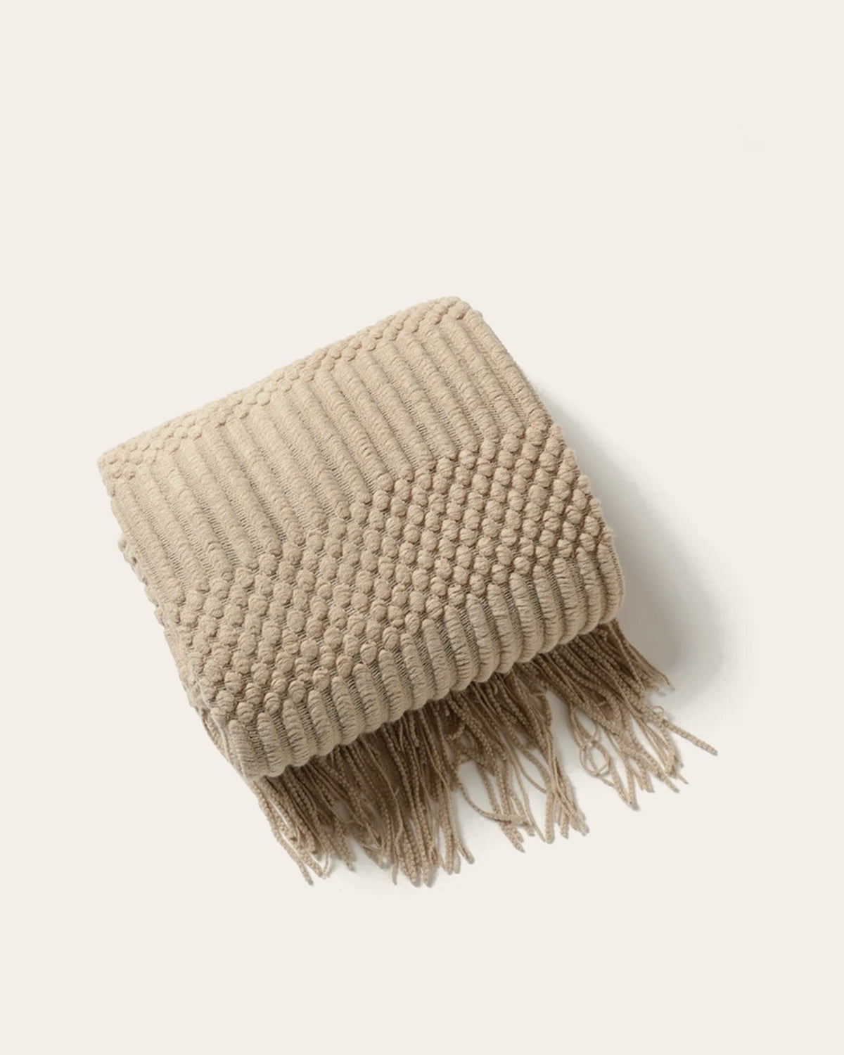 The Elsie Knitted Throw in Oat, folded