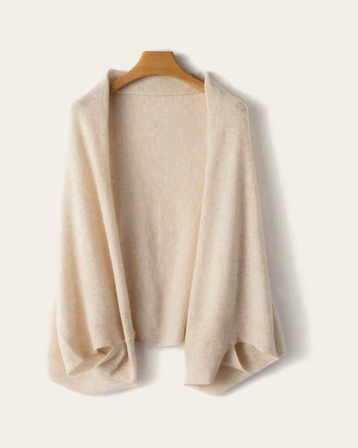 The Mabel Knit Wrap in Oatmeal on a hanger